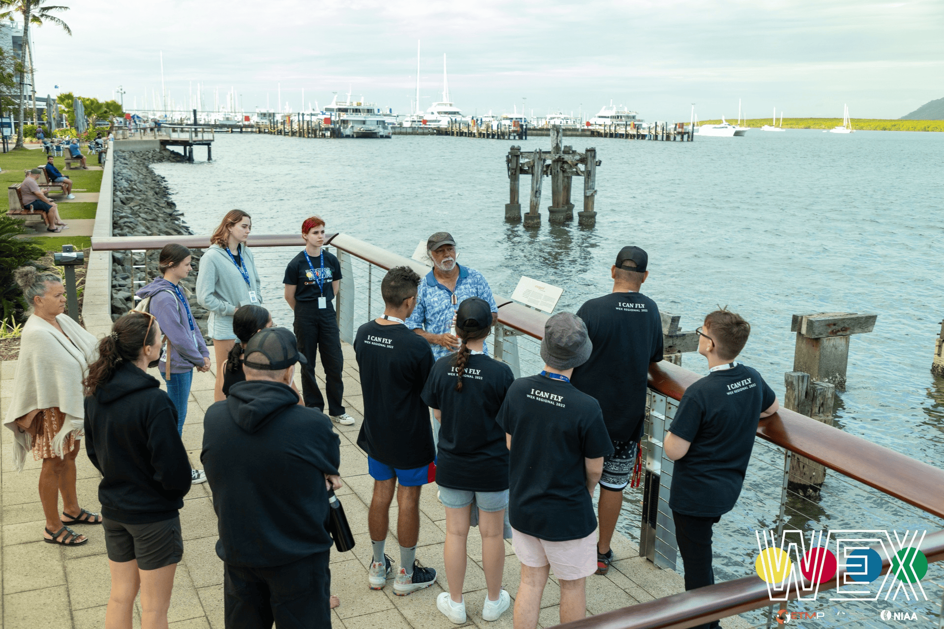 WEX Regional 2022 students gathered on a waterfront boardwalk